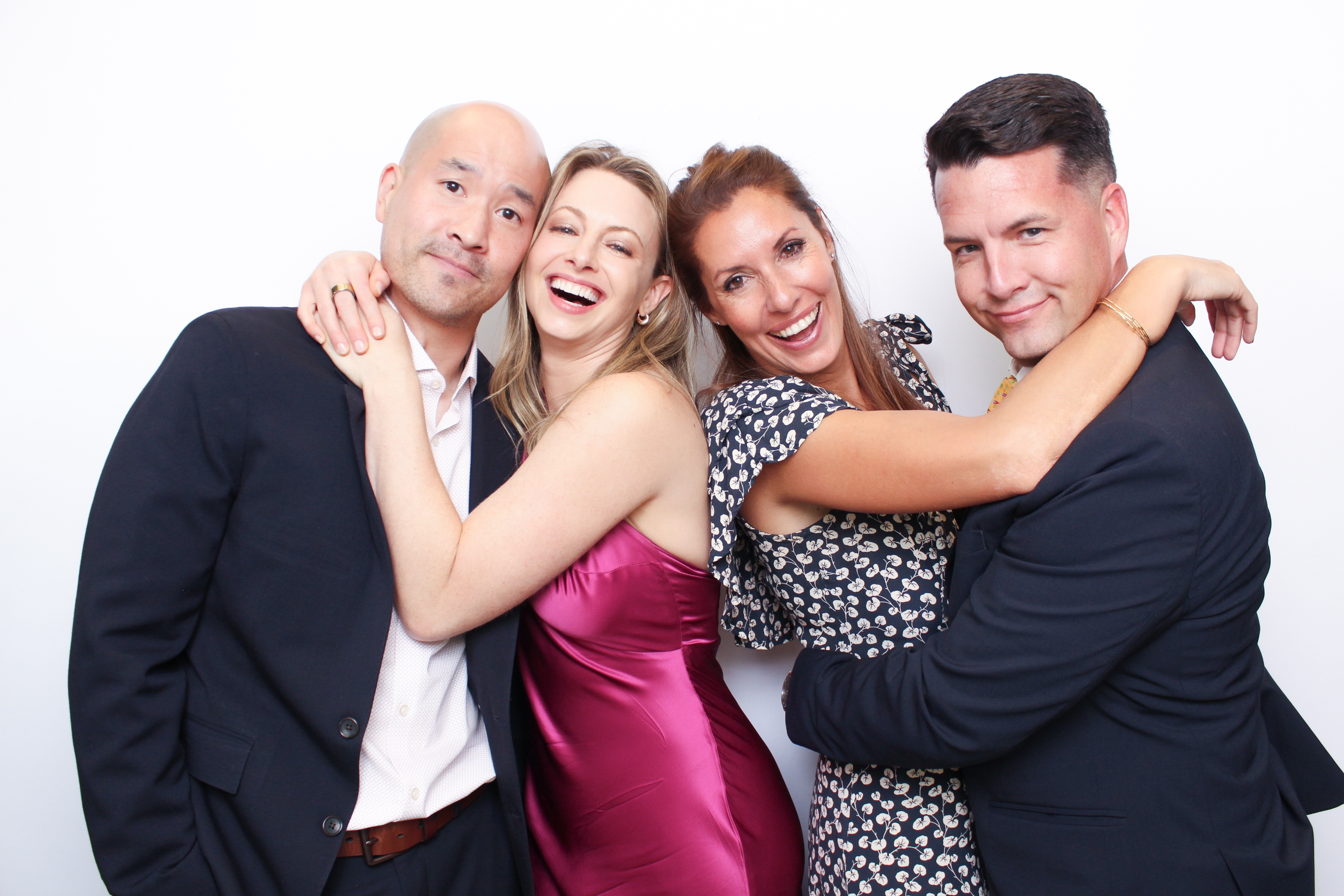 Group of four wedding guests at photo booth